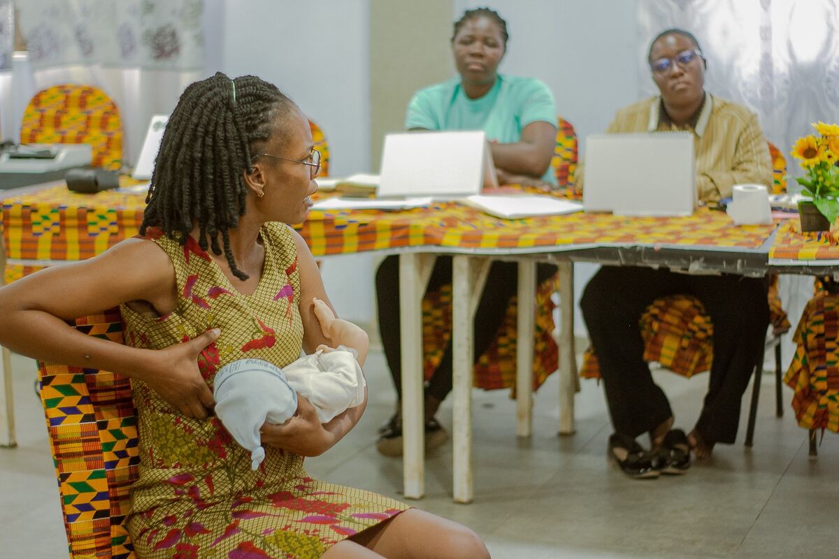Facilitator demonstrating with dummy baby
