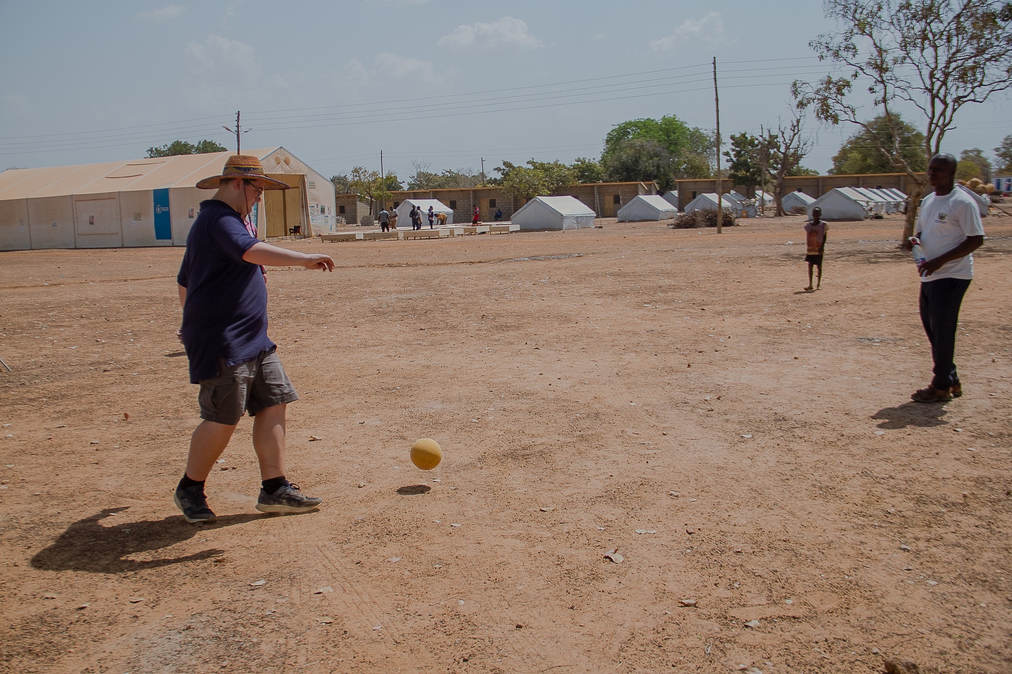 Joseph playing football with a child